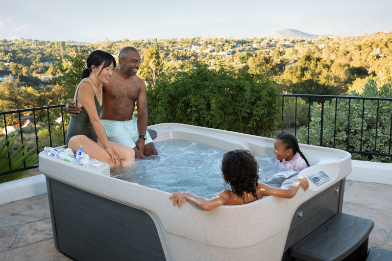 This is a lifestyle commercial photograph taken on location by Skip O'Donnell off ODonnell photograf of a Freeflow Premier Azure Sand Charcoal hot tub for Watkins Spa in Escondido, San Diego, California